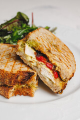 Delicious sandwich and salad on a white plate, ready for a healthy lunch