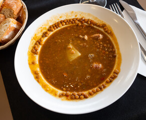 Boiled lentils with meat broth are served in plate. Thick and hearty soup is served in cafes and pubs as warming dish, snack for beer.