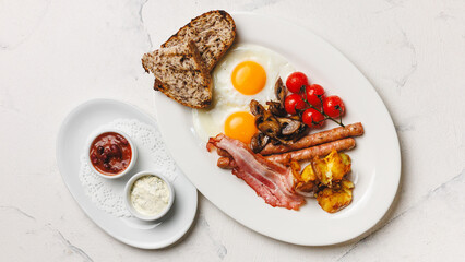 Delicious English Breakfast Fried Eggs, Sausage, Bacon, Tomatoes and Toast