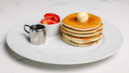 Fluffy Pancakes with Strawberries and Syrup