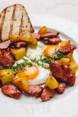 Delicious Fried Eggs with Potatoes and Sausage on a Plate