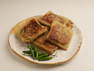Folded pastry filled with meat filling and fried until golden brown