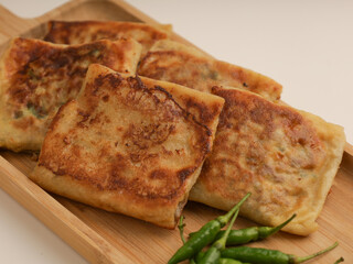 Folded pastry filled with meat filling and fried until golden brown