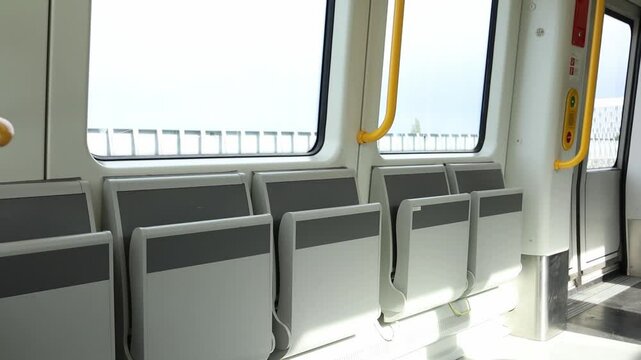 Empty modern metro cabin from inside on the move during the ride. Driverless metropolitan of Copenhagen, Denmark, clean and comfortable mode of transport.