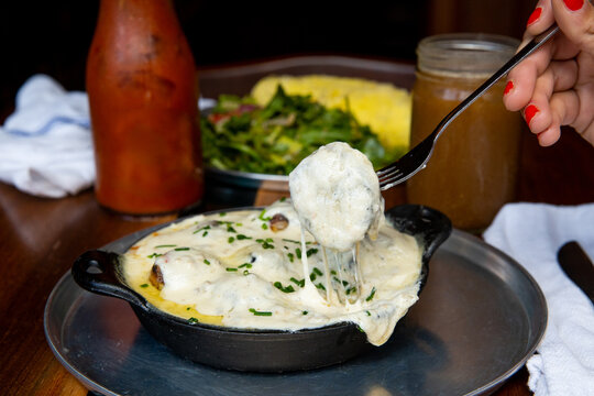 Pizza dough balls covered with gravy and cheese	