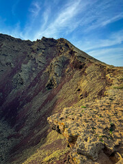Dramatic rock formations within volcanic crater of Monte Corona. Steep and textured slopes reveal...