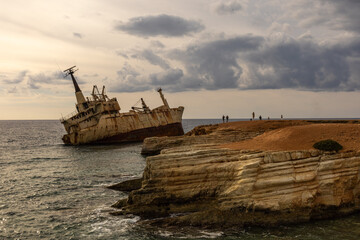 Old rust ship wreck on a rocky coast  in Mediterranean sea at Akrotiri Beach in Cyprus. Shipwreck...
