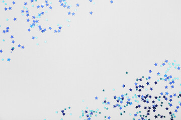 Beautiful blue confetti in shape of star on grey background