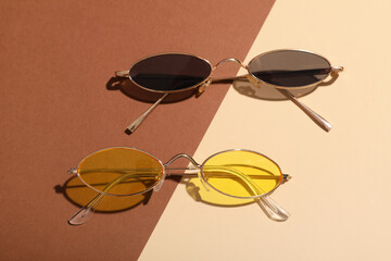 Different stylish sunglasses on colorful background