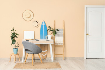 Interior of office with workplace, surfboard and ladder