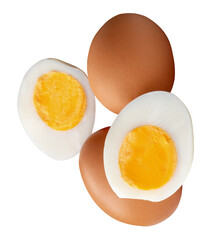 Top view of two raw chicken eggs and peeled cooked or boiled egg with egg yolk in two halves in stack isolated with clipping path in png file format