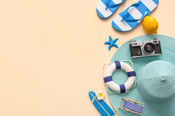 Composition with beach accessories, decorative deckchair, surfboard and lifebuoy on beige background
