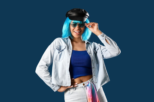 Fototapeta Stylish young African-American woman in wig on blue background