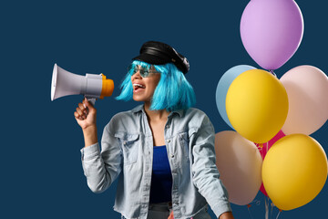 Naklejka premium Stylish young African-American woman in wig shouting into megaphone and balloons on blue background