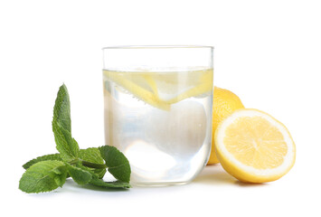 Glass of tasty lemonade, fresh lemons and mint on white background