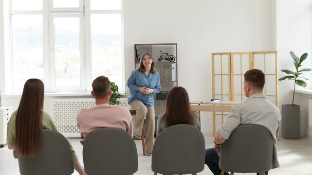 Mentor and group of people having meeting during life coaching class indoors