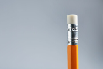 One pencil with eraser on grey background, closeup. Space for text