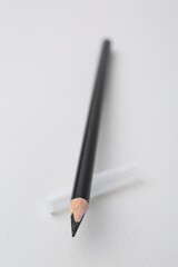 Black eyebrow pencil on light background, closeup