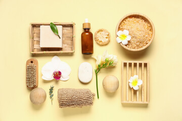 Obraz na płótnie Canvas Composition with different spa accessories, cosmetic products and flowers on color background