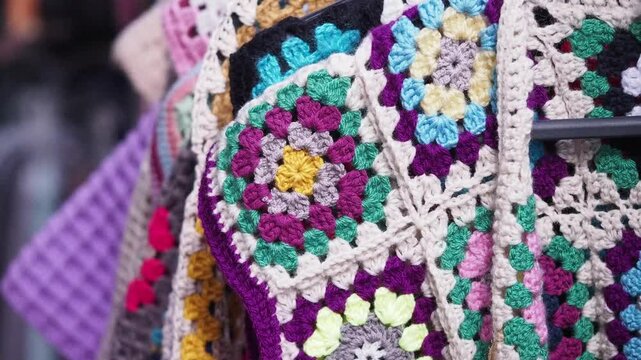 Colorful crochet blankets display at a local market
