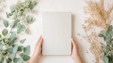 Minimalist Workspace with Blank Notebook Surrounded by Greenery
