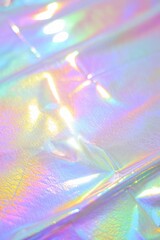 Close-up of iridescent plastic surface reflecting a spectrum of soft pastel colors with light and shadow highlights