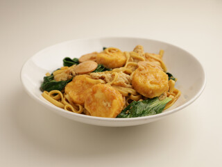Fried noodle with tofu on white plate