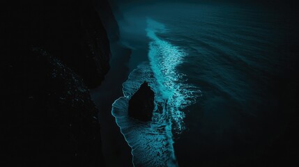 Dark, ethereal coastal scene at night.