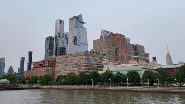 Scenic Chelsea, Hudson Yards, and Hell's Kitchen vista at sunset in the summer viewed from a pier, Manhattan, New York City