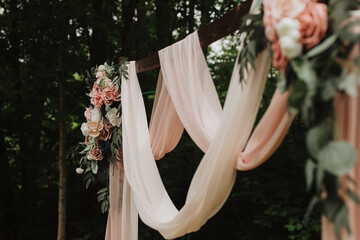 Romantic Draped Wedding Arch with Dusty Rose and Ivory Fabric and Silk Floral Details in Forest...