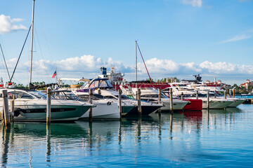 Fototapeta premium Docked charter yacht. Yachting marina. Luxury yacht charter. Miami port marina. Luxury yachting in summer. Docked yacht in Miami beach. Marina luxury cityscape. Luxurious lifestyle