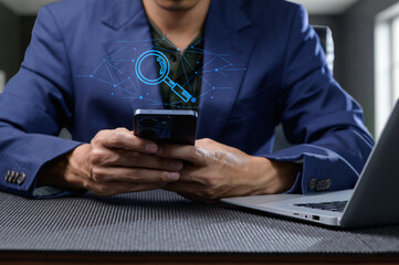 Person Searching for Information Online with Smartphone and Laptop