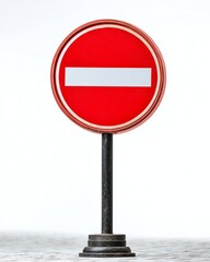 A red "no entry" road sign on a black pole, isolated on a white background