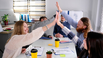 A group of joyful people are enthusiastically chatting with each other in a conference room....