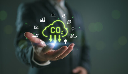 Carbon footprint reduction and eco sustainability concept with green CO2 cloud, renewable energy,...