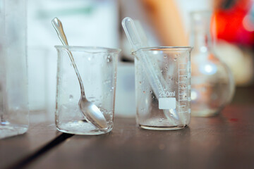 Measuring Cups and Spoons from a Chemistry Experiment. Scientific glassware at a science fair in school