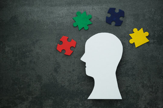 Understanding ADHD through creative visual representation with colorful puzzle pieces on concrete background. The concept of mental health and the formation of an inclusive society. top view - Powered by Adobe