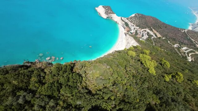FPV dive Aerial drone video of popular paradise deep turquoise beach of Porto Katsiki with white steep rocky seascape and beautiful cloudy landscape, Lefkada island, Ionian, Greece