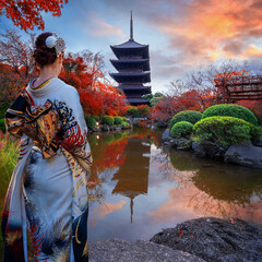 Japanese Woman in  Traditional Kimono Dress at Toji Temple in Kyoto, Japan with beautiful garden and autumn foliage