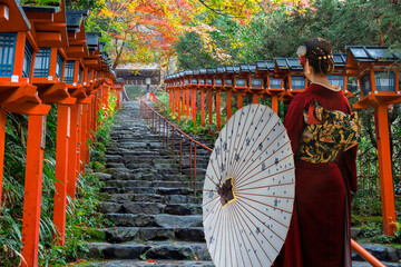 Japanese Woman in  Traditional Kimono Kifune Shrine in Kyoto, Japan with beautiful autumn scenery.