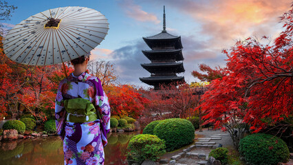 Japanese Woman in Traditional Kimono Dress at Toji Temple in Kyoto, Japan with beautiful garden and autumn foliage