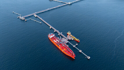 Aerial view LPG gas tanker ship at oil and gas terminal platform, Liquefied Petroleum Gas tanker ship industrial offshore oil gas terminal tanker ship LPG tanker ship loading arm loading and unloading