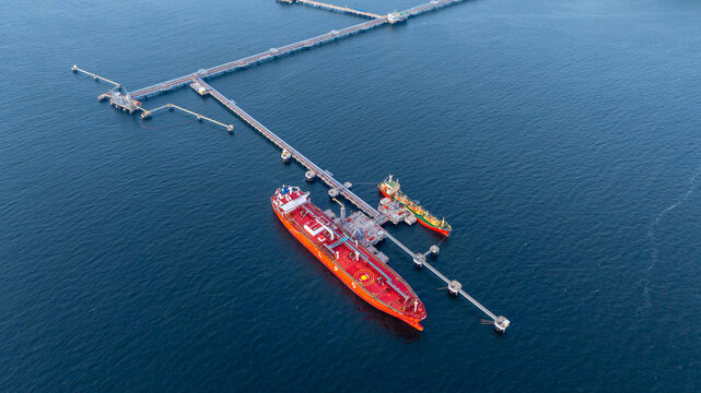 Fototapeta Aerial view LPG gas tanker ship at oil and gas terminal platform, Liquefied Petroleum Gas tanker ship industrial offshore oil gas terminal tanker ship LPG tanker ship loading arm loading and unloading