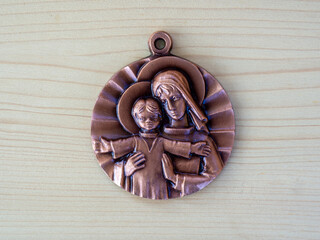 Round medallion with Saint Mary and Jesus. Symbols of Christianity. The Holy Child Blesses the World