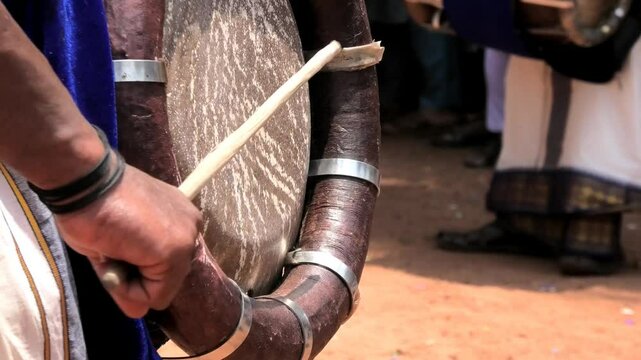 Closeup of an artist playing Thavil, a South Indian percussion musical instrument