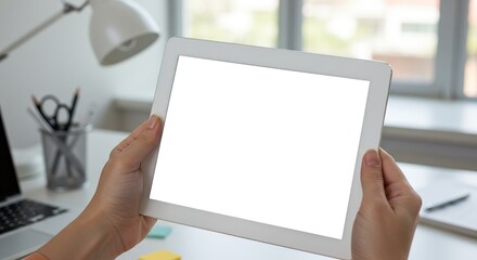 Woman holding tablet mockup for design presentation in bright office environment for advertising use on transparent background