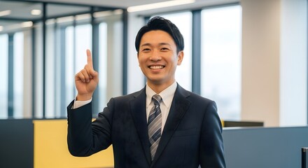 Fototapeta premium Asian business man pointing up with idea in office setting professional headshot for corporate website