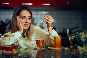 Woman Sweetens Tea Using Natural and Organic Honey. person who turns to natural alternatives to...