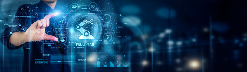 Businessman touching INDUSTRY 4.0 icons represents smart manufacturing, IoT connectivity,...