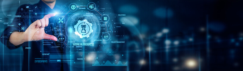 Businessman touching WORK IN PROGRESS icons symbolizes ongoing development, active projects,...